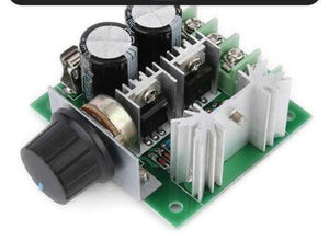 PWM Controller DC Motor Speed Controller 12V-40V 10A - a green circuit board with two black capacitors, two silver heatsinks, and a black rotary knob.