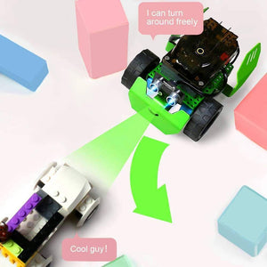 Q-scout STEM Robot For Kids By Robobloq - a green and black robotic toy with two front-facing sensors, shown turning away from a white building block vehicle.
