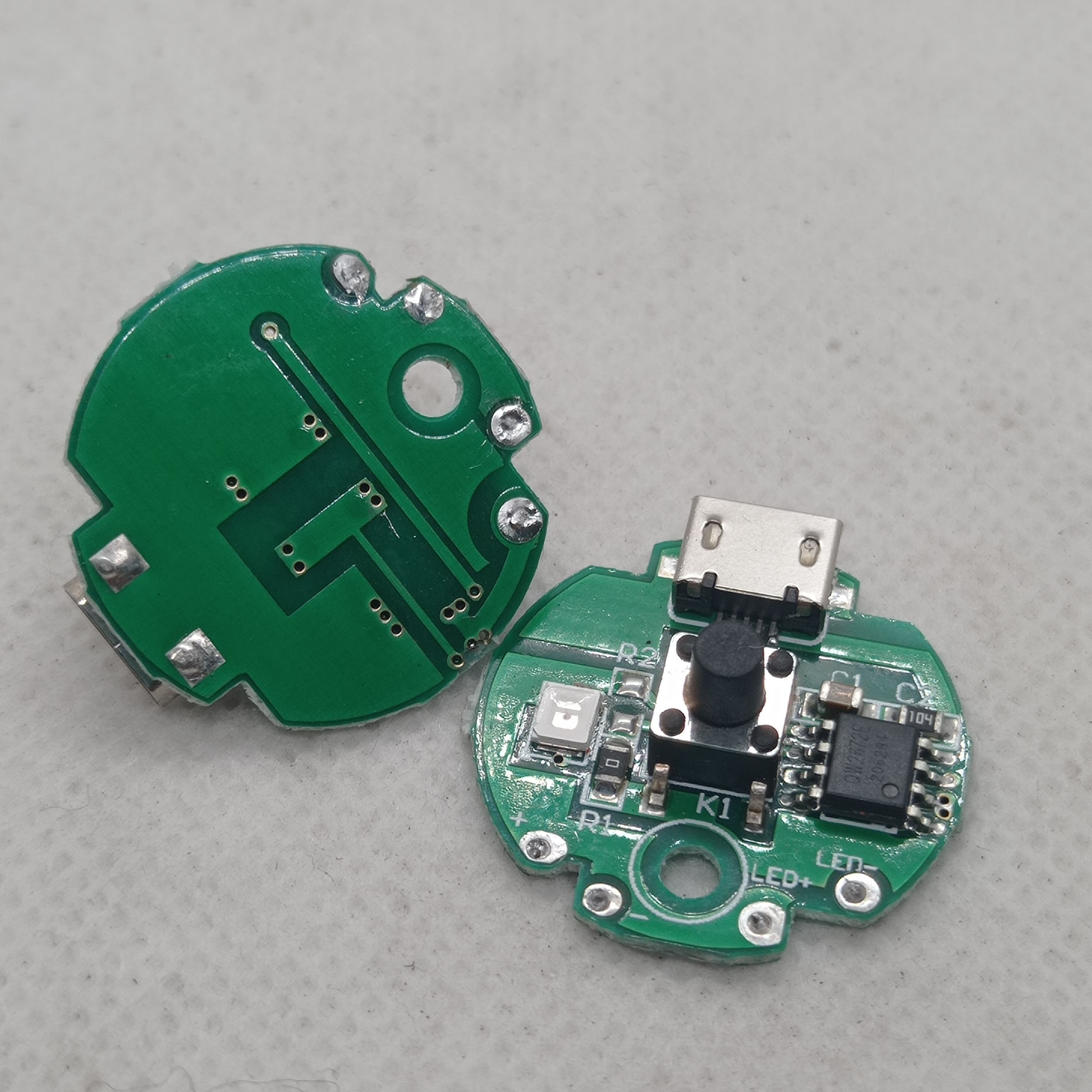 QW2672 Torch Light Emergency Light Controller Module - shown as two green circular circuit boards with a micro-USB port, a push button, and LED pads.