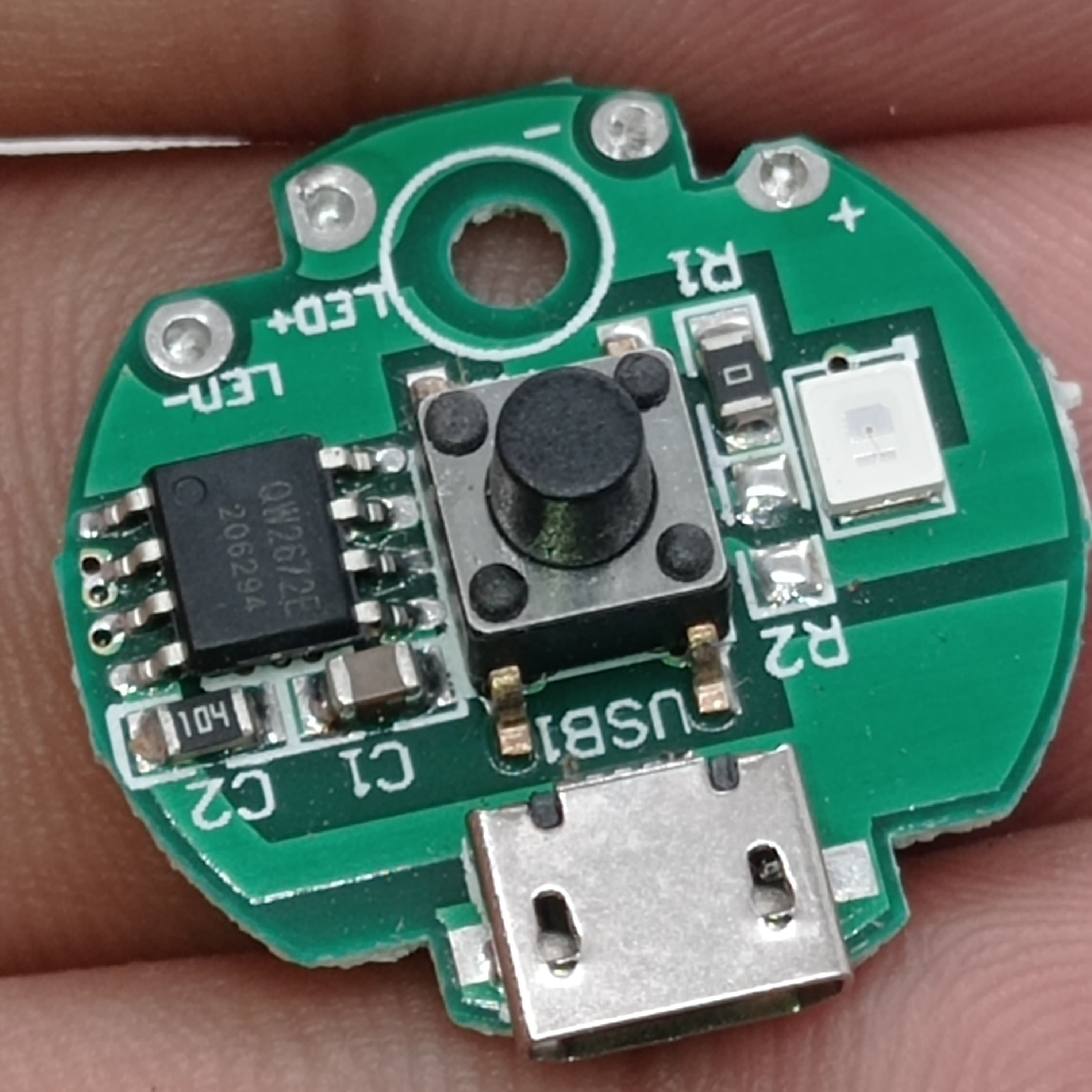 QW2672 Torch Light Emergency Light Controller Module - a circular green circuit board with a micro-USB port, a push button, an LED, and a chip.