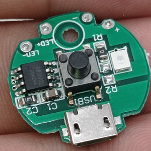 QW2672 Torch Light Emergency Light Controller Module - a circular green circuit board with a micro-USB port, a push button, an LED, and a chip.