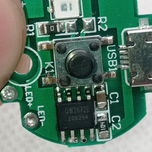 QW2672 Torch Light Emergency Light Controller Module - a close-up of a green circuit board featuring a black push button, a micro-USB port, and an IC chip.