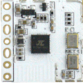 RA24D18 24GHz Presence Sensor Module – Bluetooth Version 5.0, Human Detection & Occupancy Monitoring - a close-up of a white rectangular circuit board with a central black chip, two gold oscillators, and side pins.