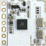 RA24D18 24GHz Presence Sensor Module – Bluetooth Version 5.0, Human Detection & Occupancy Monitoring - a close-up of a white rectangular circuit board with a central black chip, two gold oscillators, and side pins.