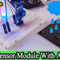 Rain Sensor with Arduino Uno - a sensor board, a breadboard with a blue LED, and a rain detection plate connected by jumper wires.