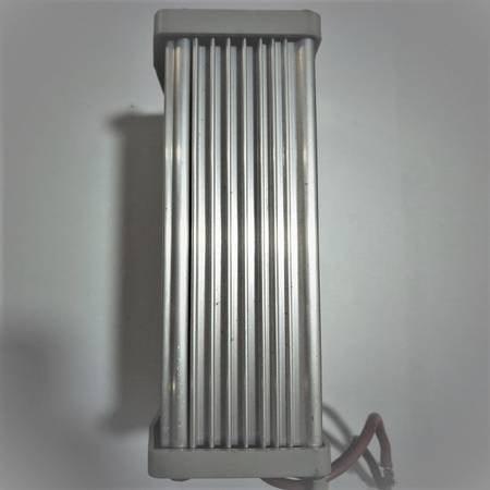 Rainproof Switching Power Supply 12V 120W For Outdoor LED Landscape Lighting - a side view of the silver, rectangular, ribbed metal housing with a red wire extending from the base.