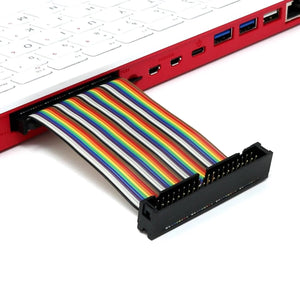 Raspberry Pi 400 4GB RAM Your Complete Personal Computer, Built Into a Compact Keyboard-digilog.pk - a red keyboard computer with a multi-coloured GPIO ribbon cable connected to its side port and extending to a black header connector.