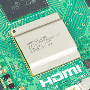 Raspberry Pi 5 4GB - the Broadcom processor with a metal heat spreader on a green circuit board next to an HDMI port label.