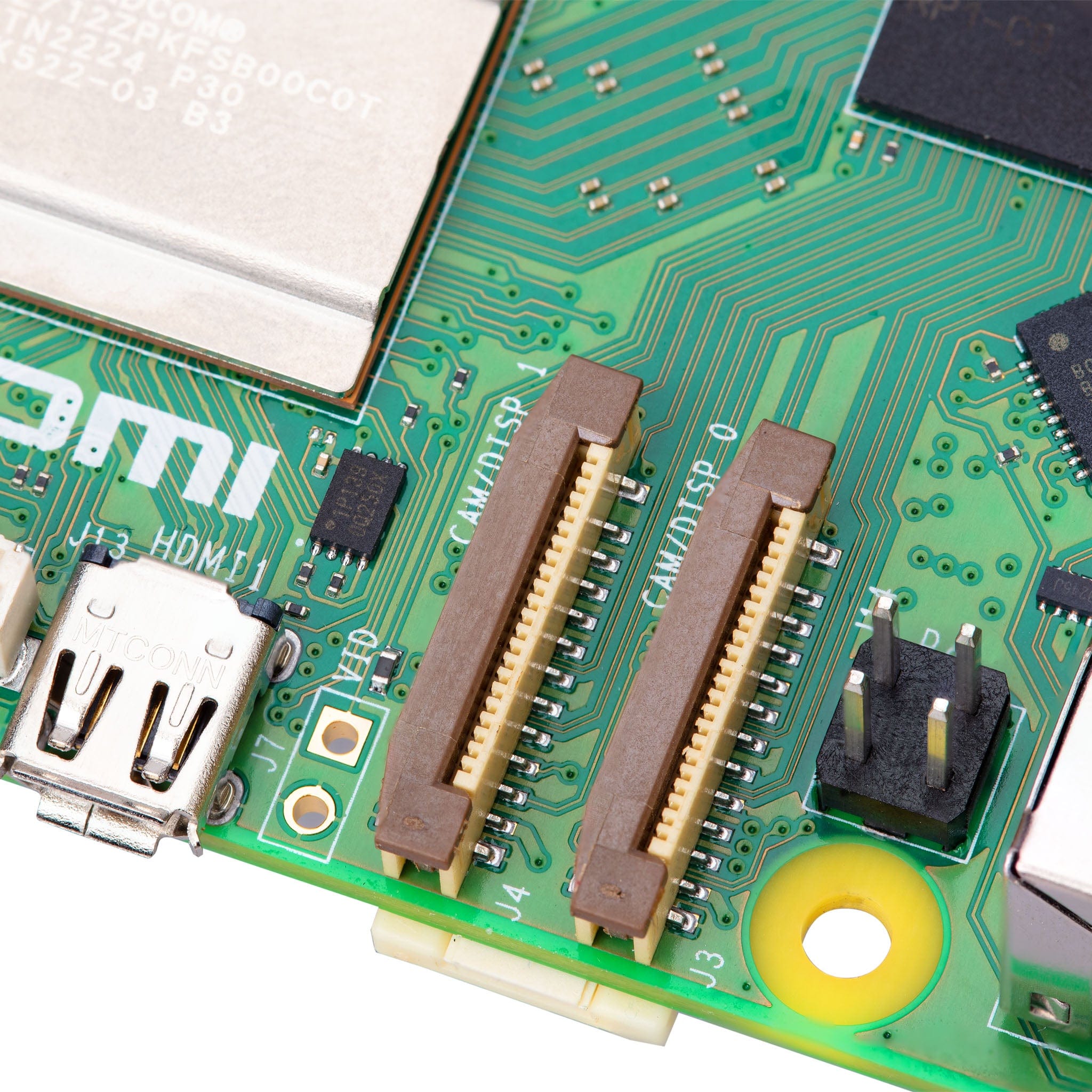 Raspberry Pi 5 4GB - a close-up of the green circuit board showing two brown CAM/DISP ribbon cable connectors, an HDMI port, and a two-pin header.