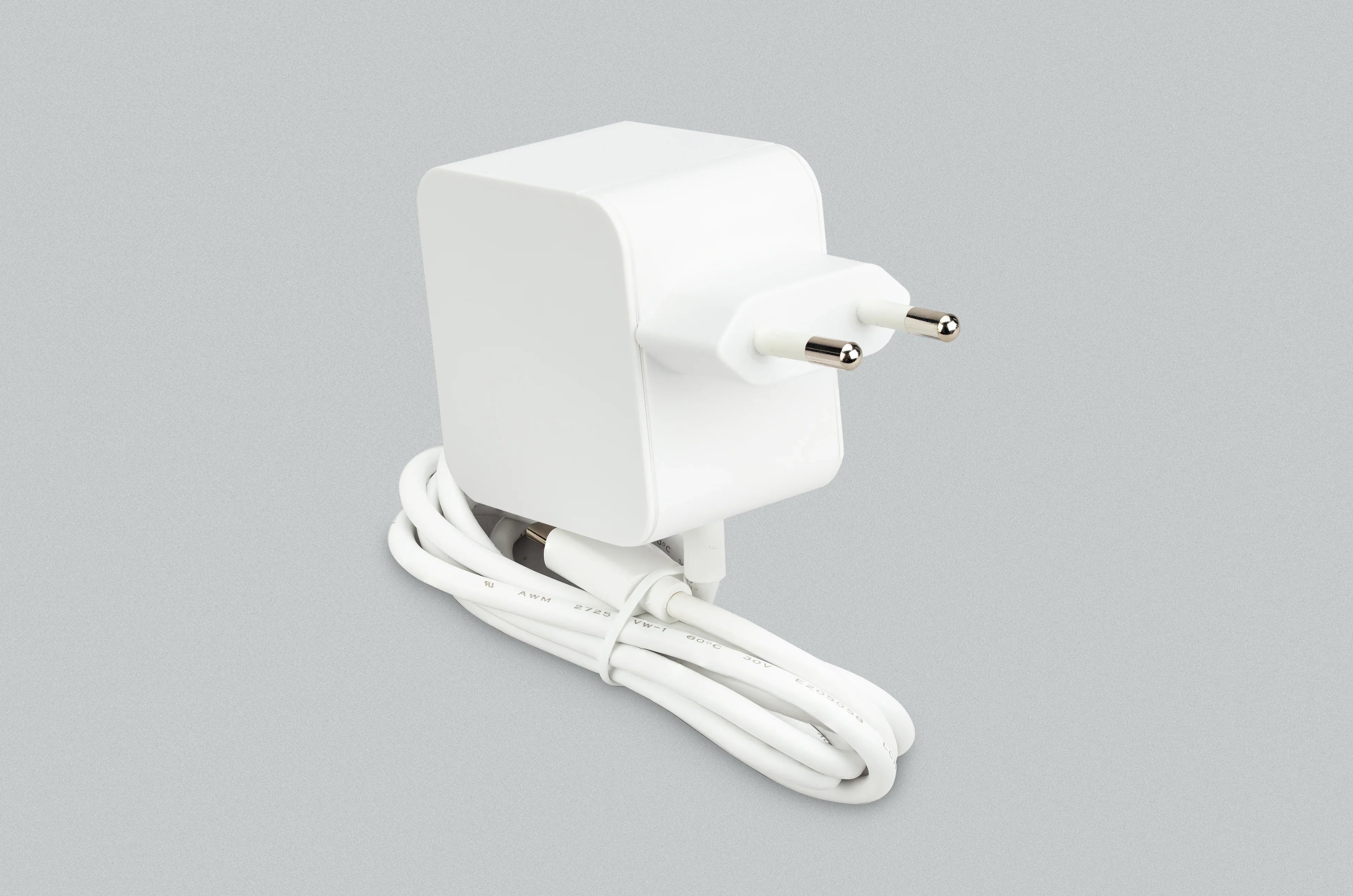 Raspberry Pi 5: Official 27W 5.1V 5A USB-C Power Supply - a white plug-in adapter with a two-pin European plug and coiled captive white cable.