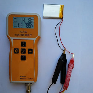 RC3563 Battery Internal Resistance Tester - a yellow handheld device with a display reading 114.18mΩ and 3.795V connected to a lithium battery.
