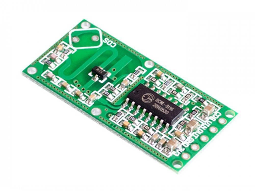 Rcwl 0516 Microwave Radar Sensor Module - a green rectangular circuit board with an integrated chip, surface-mount components, and six pin headers.