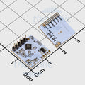 Rd-04 AI-thinker 3-3.6V Human Presence Sensor Radar 10.525GHz - the blue circuit board with a six-pin header and labeled ports on a grid background.