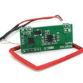 RDM6300 RFID Card Reader Module - a green circuit board with two black integrated circuits and a rectangular red wire antenna coil.