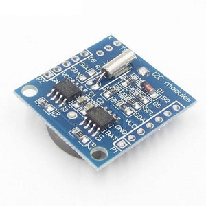 Real Time Clock DS1307 Ds 1307 RTC I2c Module AT24C32 - a blue rectangular circuit board with a silver crystal oscillator and two integrated circuit chips.