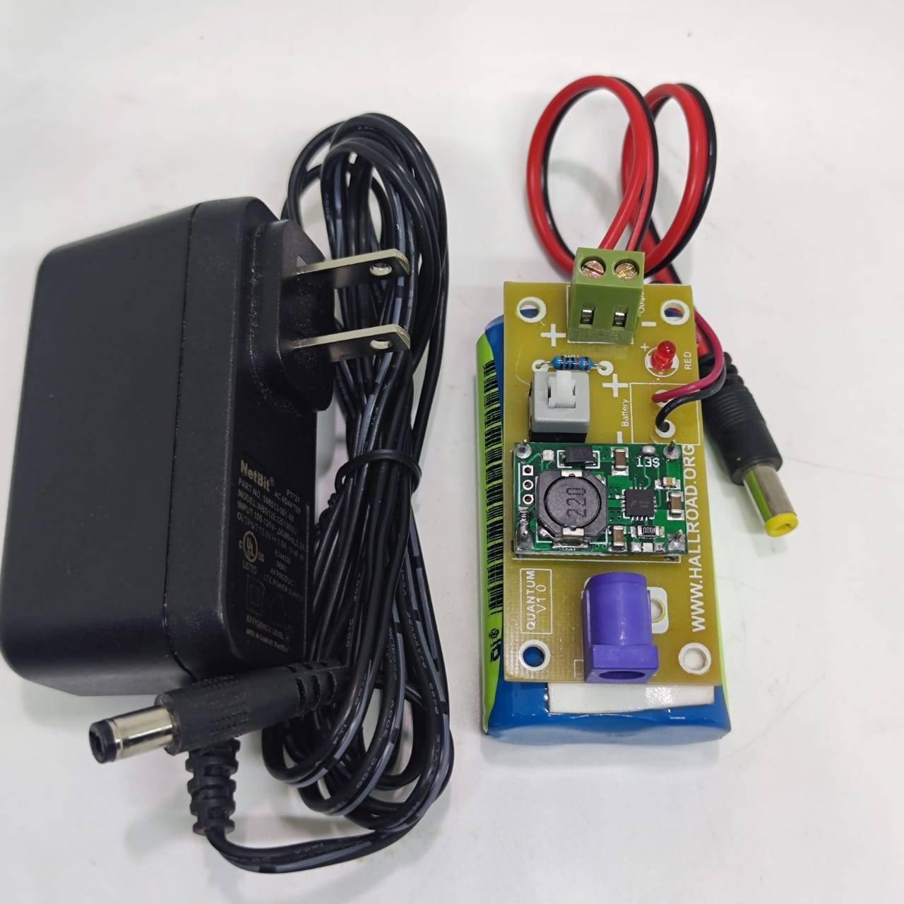 Rechargeable Battery Pack For Arduino And Robot Power Supply With Charger - a blue battery pack with a circuit board, power switch, and AC adapter.