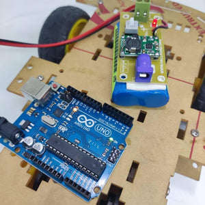 Rechargeable Battery Pack For Arduino And Robot Power Supply With Charger - shown mounted on a robot chassis with an Arduino Uno and power module.