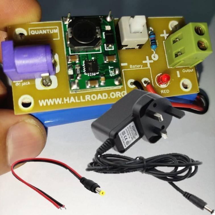 Rechargeable Battery Pack For Arduino And Robot Power Supply With Charger - a circuit board with a DC jack, switch, LED, and power adapter.