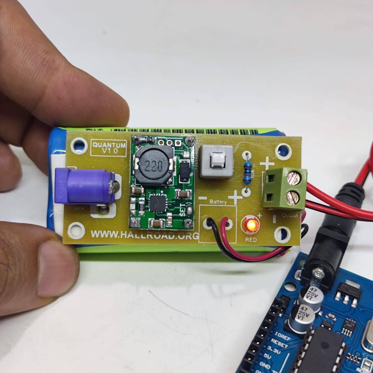Rechargeable Battery Pack For Arduino And Robot Power Supply With Charger - a green battery with a circuit board, power jack, and red LED.
