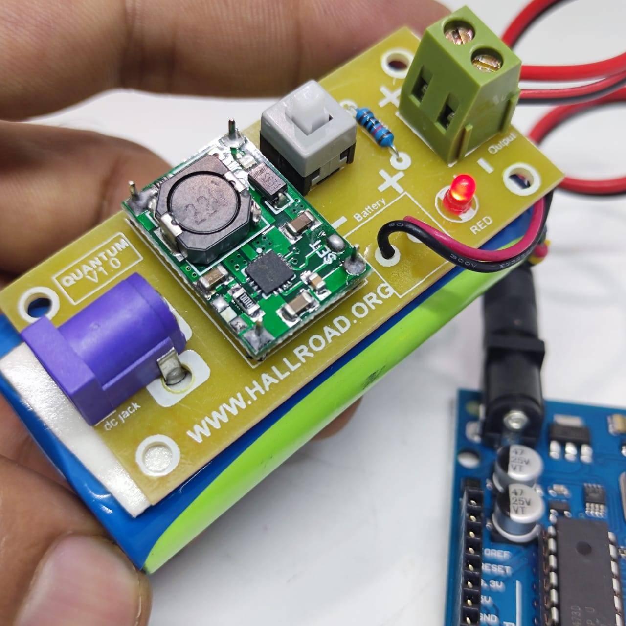 Rechargeable Battery Pack For Arduino And Robot Power Supply With Charger - a green circuit board with a purple DC jack, button, and red LED.