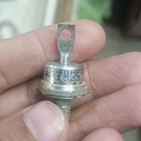 Rectifier Diode 40HFR120 Iron Replacement Stable 40A Diode - a silver-colored stud-mount diode held in a hand, featuring a threaded base and a top terminal with a hole.