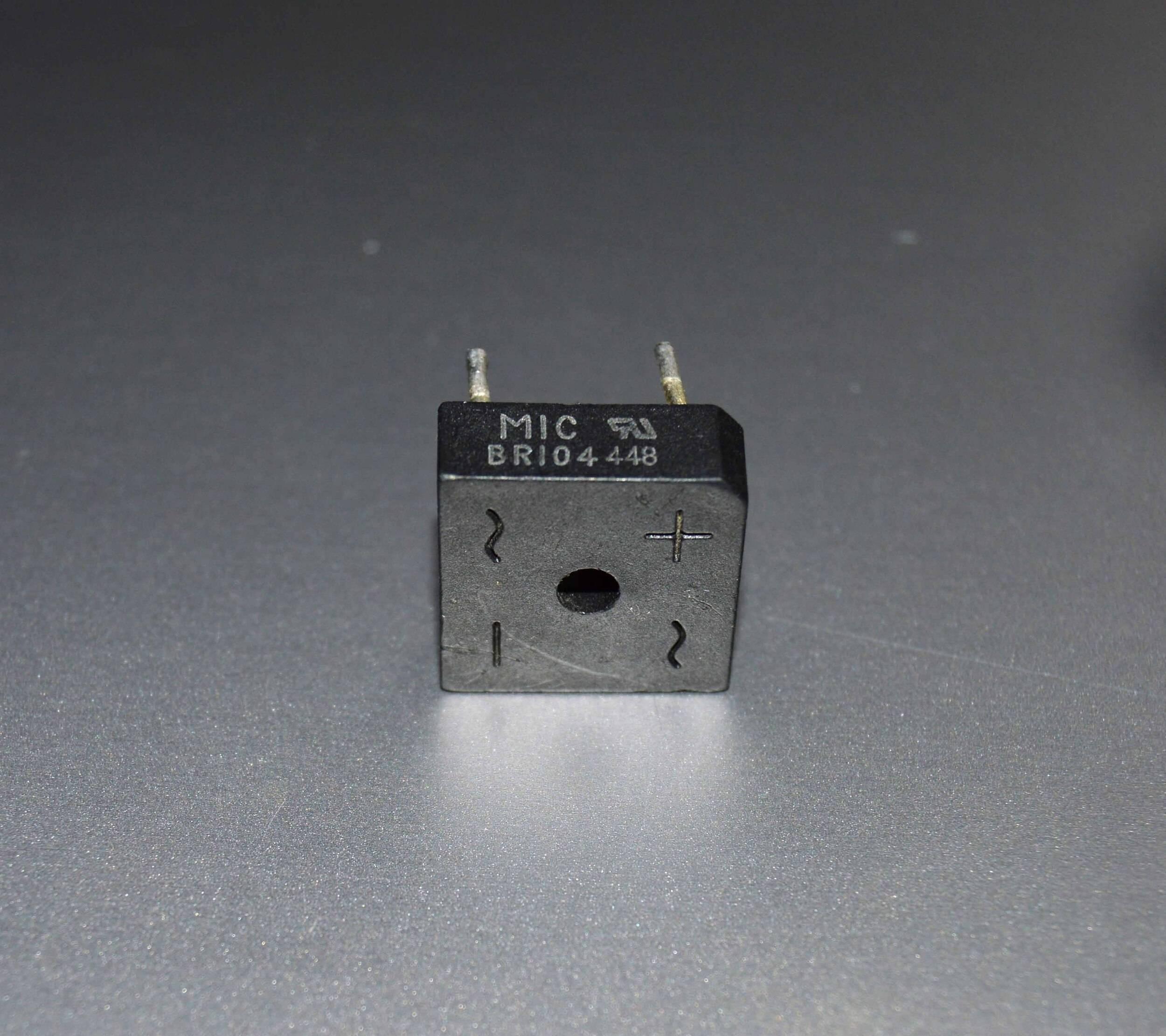 Rectron Bridge Ractifier BR104 (used Condition) - a black square-shaped electronic component with four pins and markings for AC inputs and positive/negative terminals.
