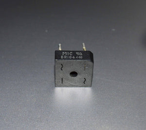 Rectron Bridge Ractifier BR104 (used Condition) - a black square-shaped electronic component with four pins and markings for AC inputs and positive/negative terminals.