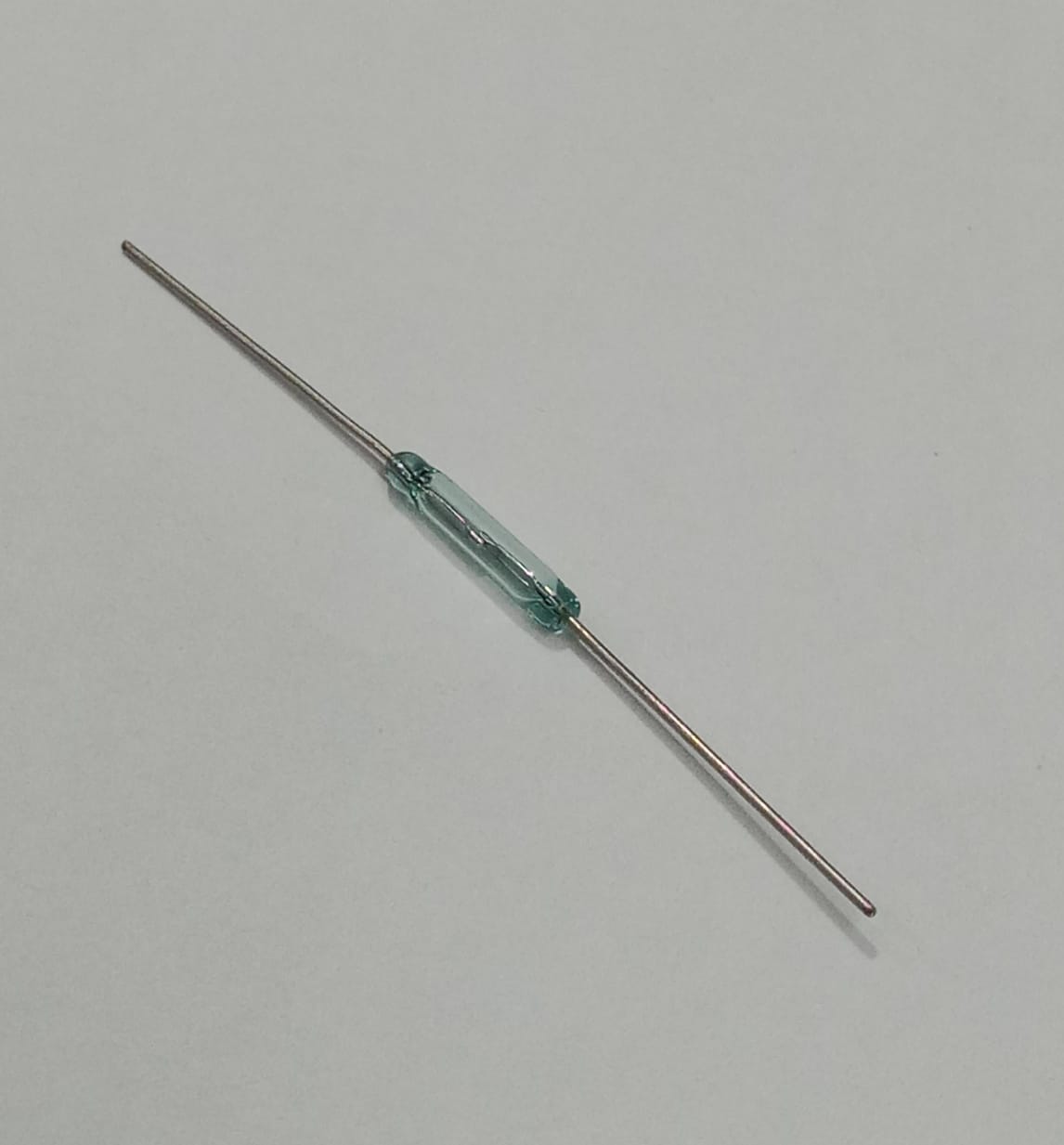 Reed Switch Sensor Reed Sensor Magneto Magnet Magnetic Switch Normally Close - a small, clear glass cylindrical component with two thin metal leads extending from opposite ends, isolated on a white background.