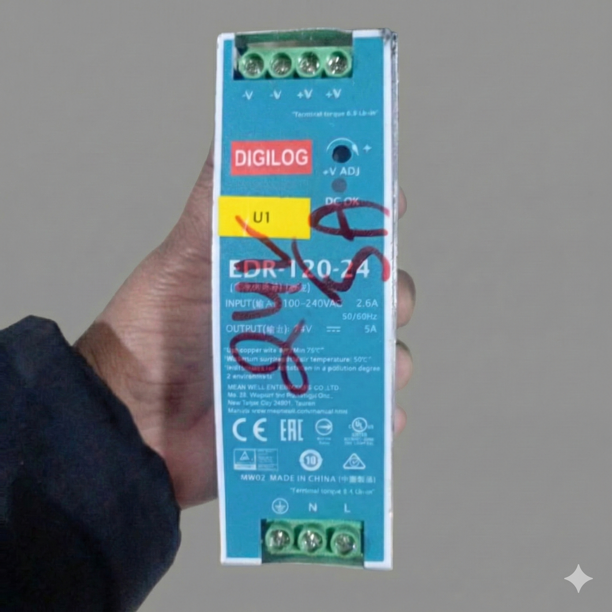 Refurbished Mean Well MDR-120-24 DIN Rail Power Supply 24V 5A 120W - a teal rectangular unit held in a hand, showing input/output screw terminals, a voltage adjust knob and label.