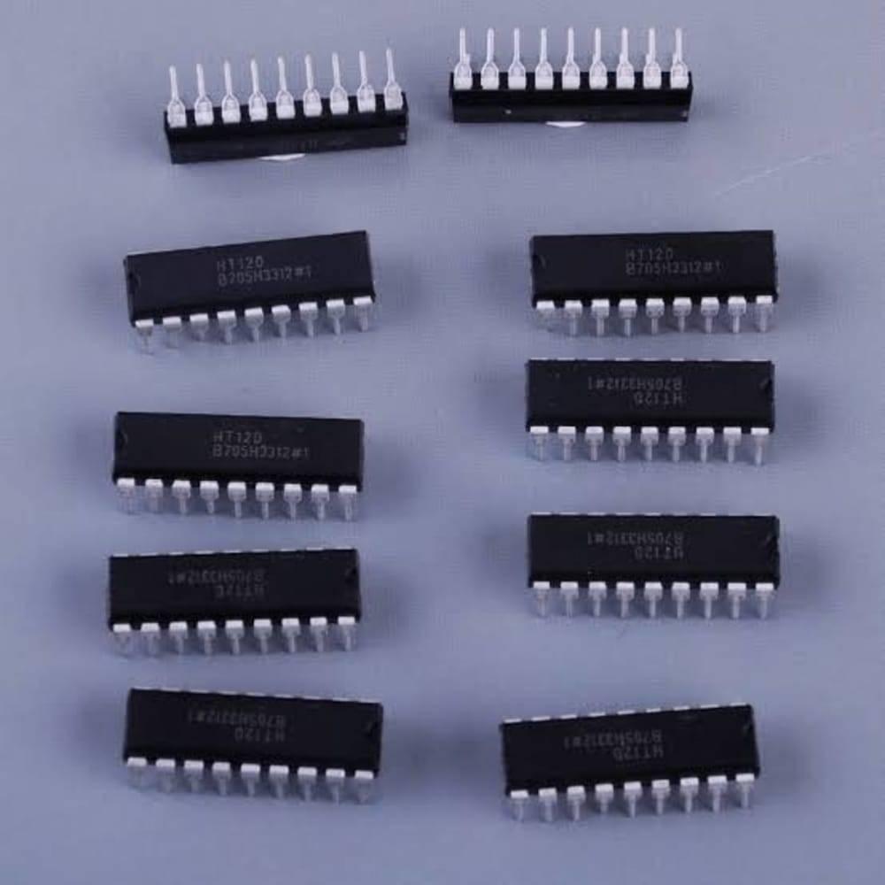 RF Decoder IC HT12D 18 Pin DIP - a collection of eight black rectangular integrated circuits with silver pins arranged on a grey surface.