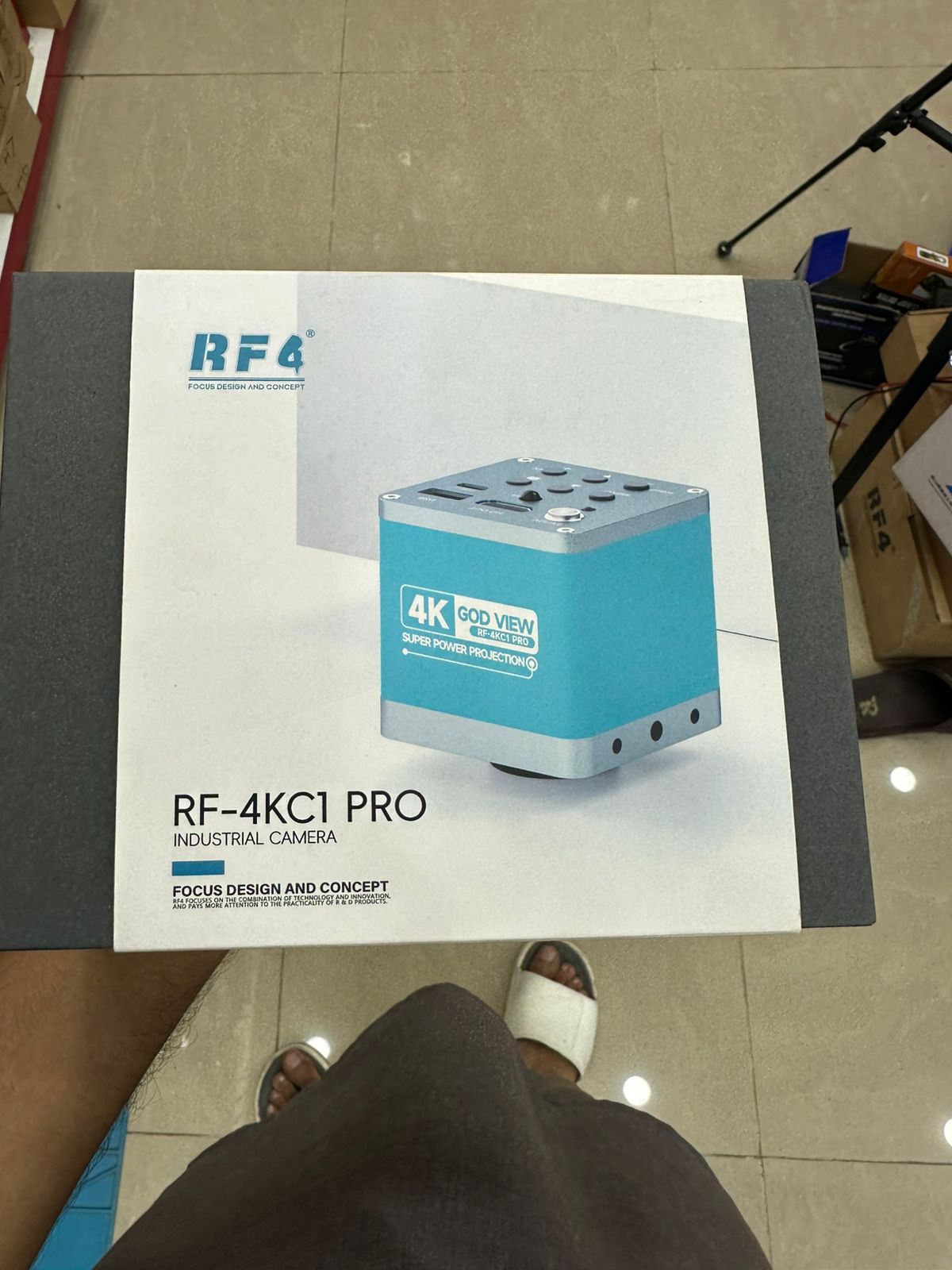 RF4 RF-4KC7 Large Field 4k Industrial Camera for Microscope in Pakistan - RF4 RF-4KC1 PRO industrial camera box showing a teal and silver square camera with top-mounted ports and buttons on the product packaging.