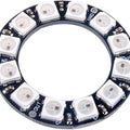 RGB LED Ring 12Bit WS2812 5050 Integrated Driver Module for Arduino - a circular black PCB featuring twelve white LEDs with labeled GND, PWR, IN, and OUT ports.