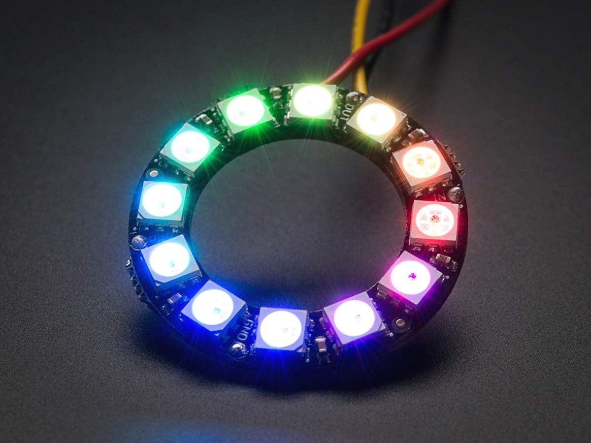 RGB LED Ring 12Bit WS2812 5050 Integrated Driver Module for Arduino - a circular black PCB with twelve glowing multi-coloured LEDs and wiring.