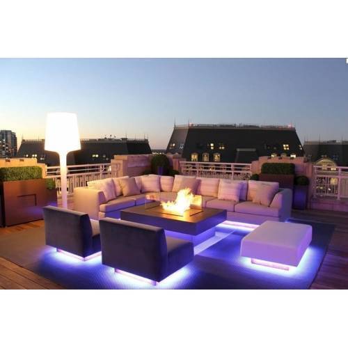 RGB LED Strip 30 LED Per Meter 5 Meter Roll 5050 Size 12V - 12V installed under outdoor patio furniture, emitting a bright purple glow on the floor.