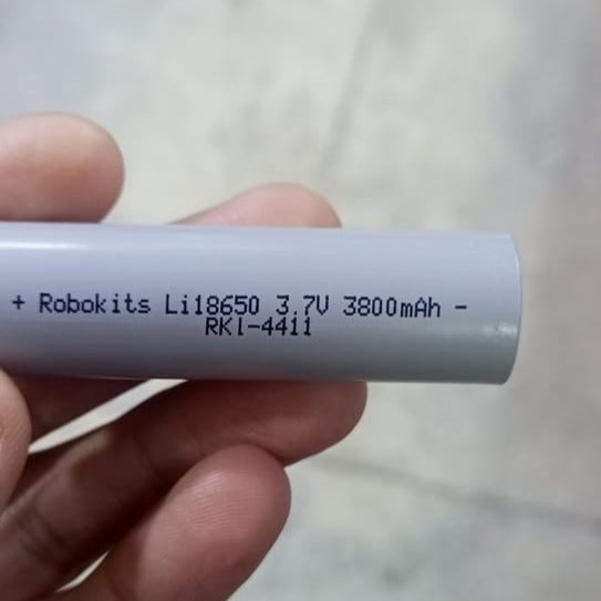 ROBOKITS LITHIUM-ION 18650 RECHARGEABLE CELL 3.7V 2000mAh - a close-up of a grey cylindrical battery showing printed text including 3.7V and 3800mAh specifications.