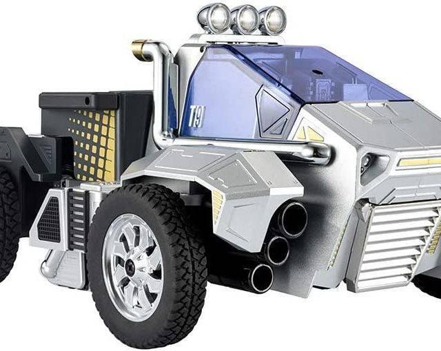 Robosen T9 - Advanced Programmable And Convertible Robot - STEM: Fun, Educational With Voice And App Control - a silver and black robotic vehicle featuring a blue windshield, three roof-mounted lights, and a side-mounted exhaust pipe.