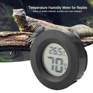 Round LCD Hygrometer Thermometer Temperature Humidity Meter - a black circular digital meter displaying 26.5°C and 70% humidity, shown against a background image of a lizard.