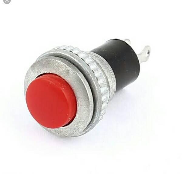 Round Push Button Switch - a red circular button set in a metallic housing with two metal terminals extending from the black cylindrical base.