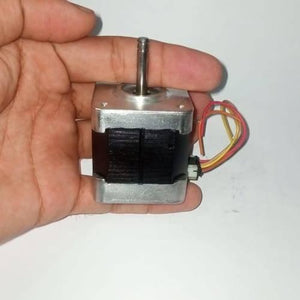 Round Shaft NEMA17 Stepper Motor For 3d Printer & CNC - held in a hand, showing the silver metal body, black motor casing, vertical shaft, and a small white connector with wires.