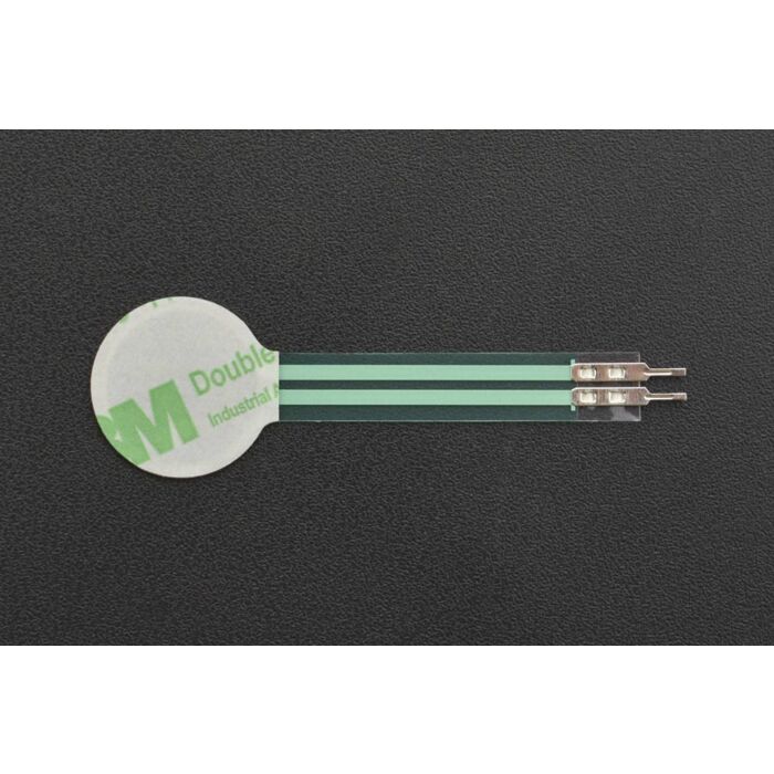 RP-C18.3-LT Thin Film Pressure Sensor - a circular white adhesive pad connected to a flat green ribbon cable with two metal pin connectors at the end.