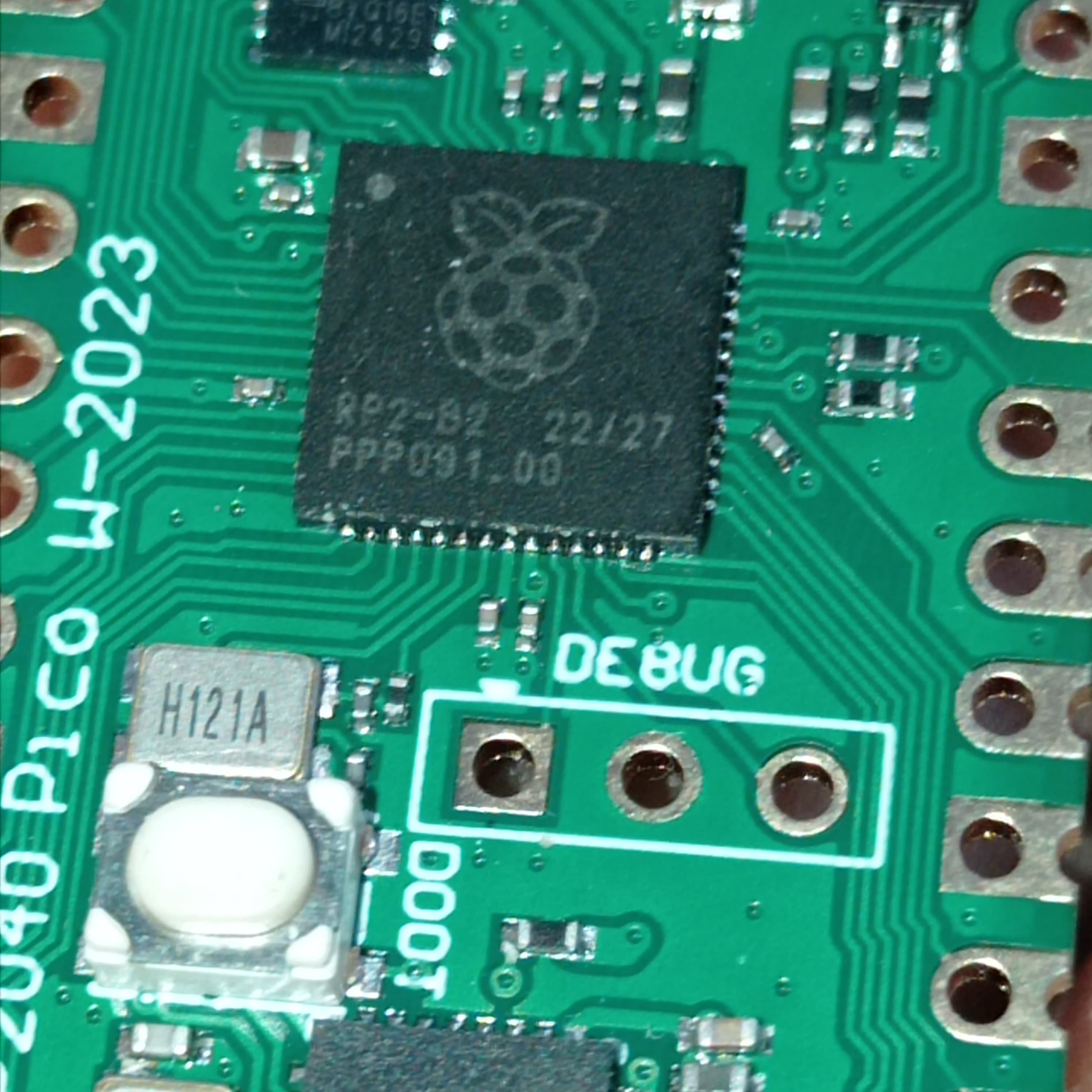 RP2040 Raspberry Pi Pico W Board with 2.4G WiFi Micro Dual-Core 264KB ARM Microcomputers High-Performance Cortex-M0 Processor - close-up of the green circuit board showing the RP2040 chip, a white push button, and a three-pin debug header.