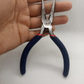 Santus St502 Needle Nose Plier Needle Nose Plier - with blue rubberized handles and a spring-loaded hinge being held in a hand against a white background.