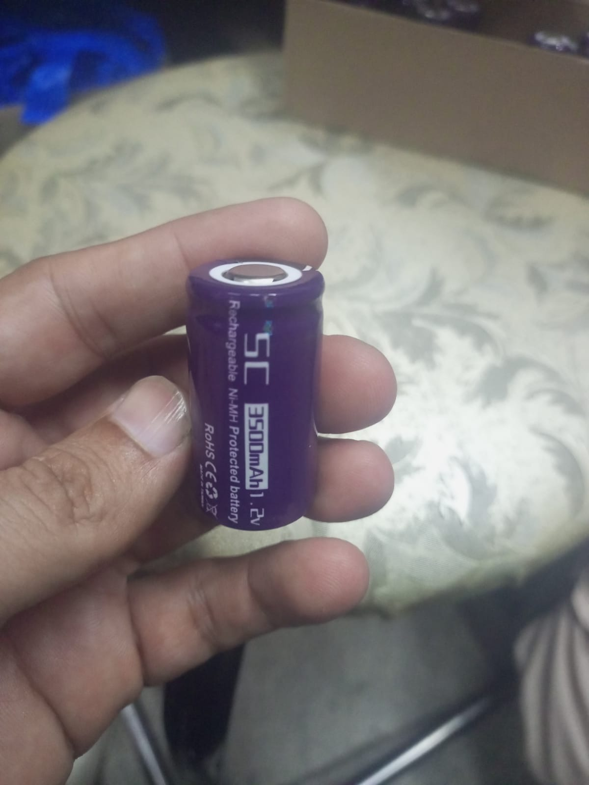 SC 3500mAh 1.2V NiMH Rechargeable Battery - a purple cylindrical cell held in a hand, showing the printed capacity, voltage, and chemistry specifications.