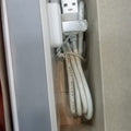 security monitoring 5V 2amp battery - a white power adapter with a USB-A port and a connected white USB cable, shown inside its cardboard packaging.