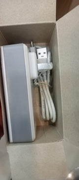 security monitoring 5V 2amp battery - a white power adapter with a USB-A port and a connected white USB cable, shown inside its cardboard packaging.