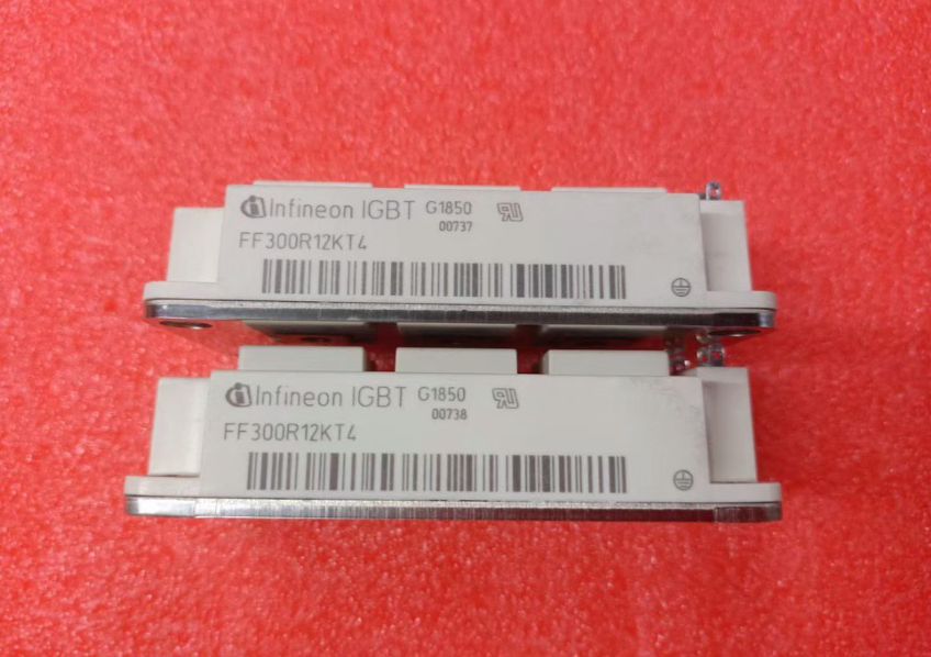 Semikron 300A Infineon FF300R12KT4 IGBT Module, 1200 V | Digilog.pk - two white rectangular power modules with metal bases and printed labels, resting on a red surface.