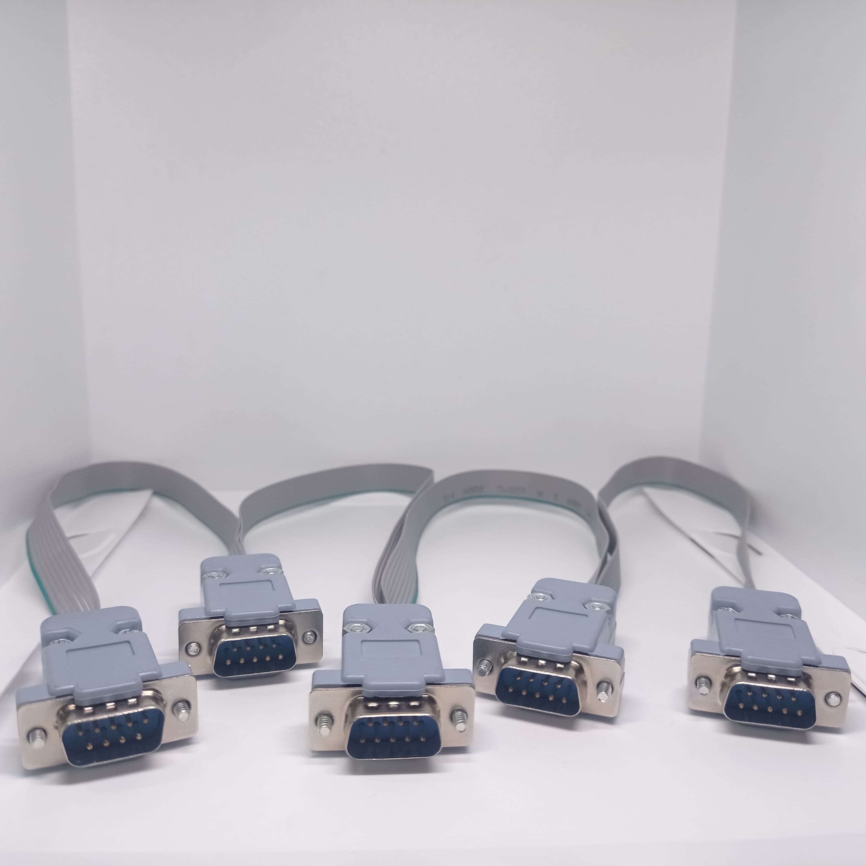 Serial Modbus Daisy Chain Cable - shown as a set of five grey ribbon cables, each with a 9-pin male D-sub connector on one end and a female end on other.