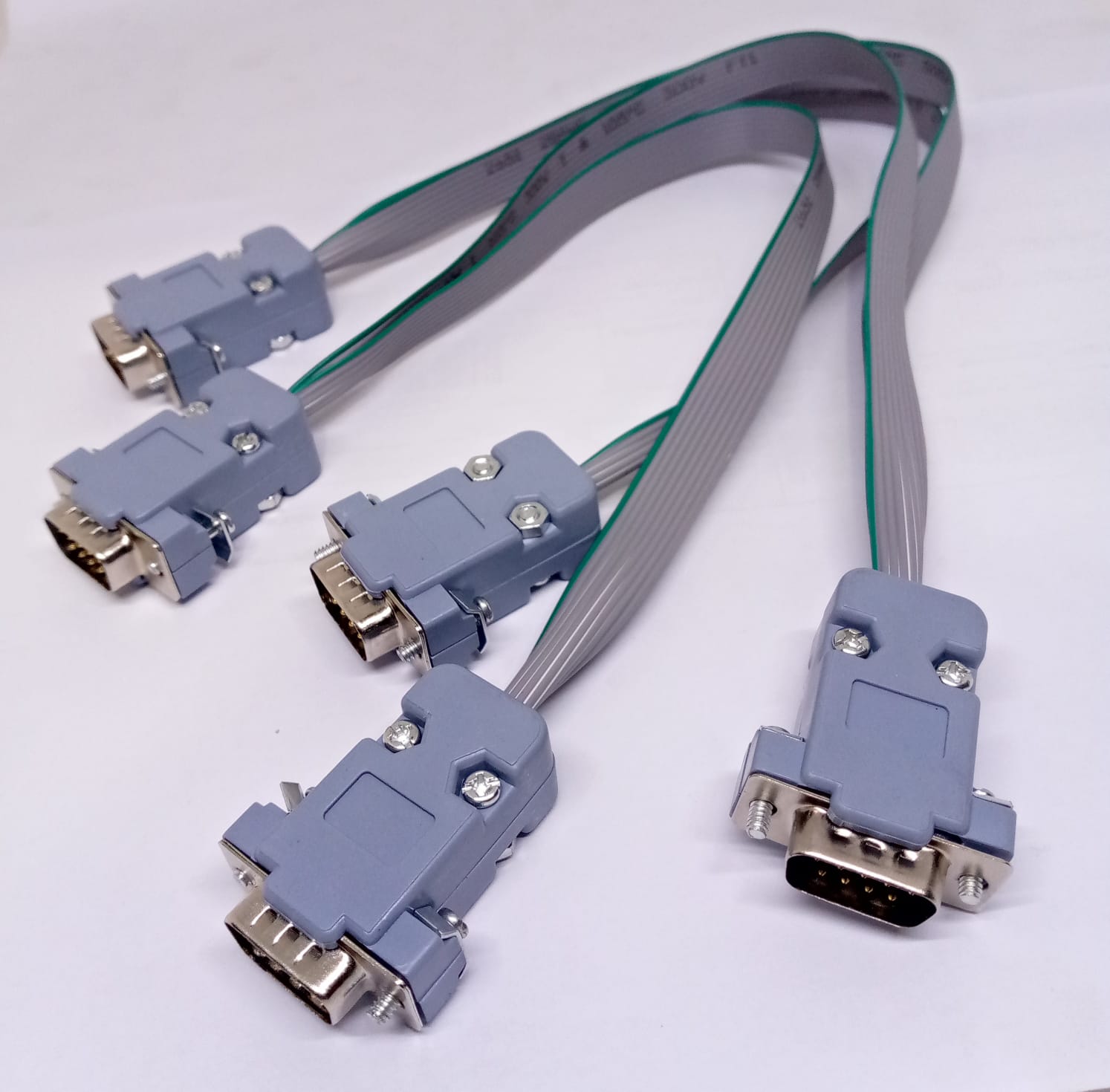 Serial Modbus Daisy Chain Cable - four grey DB9 connectors linked by grey ribbon cables on a white background.
