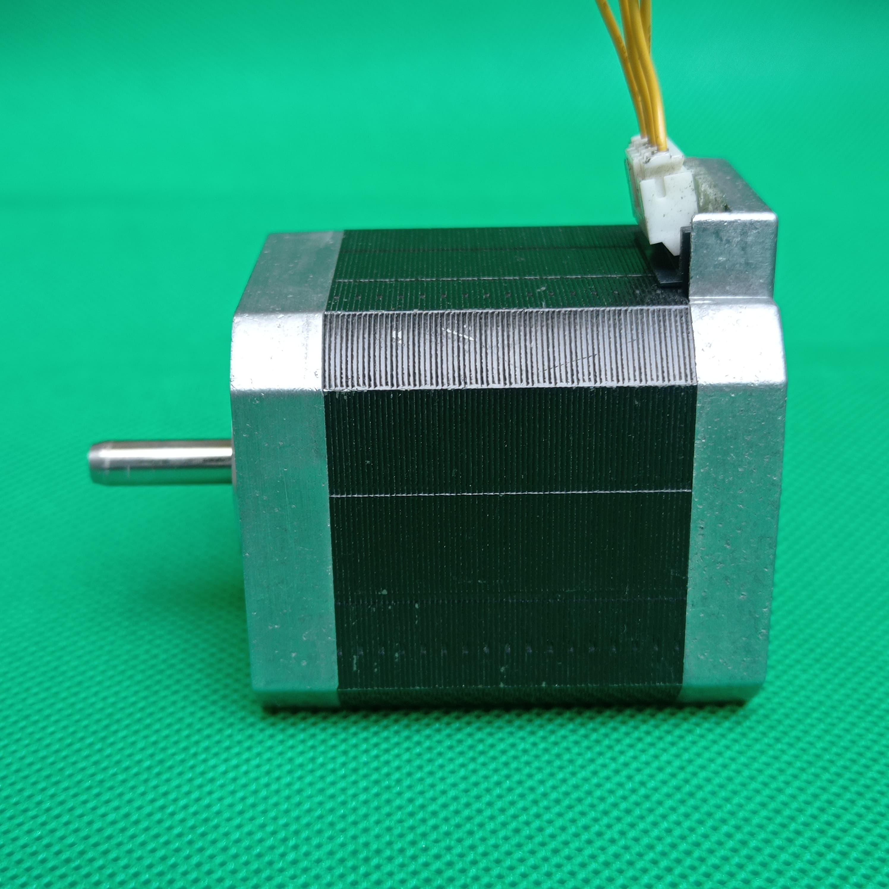 Shinano Kenshi STP-42D4042 2A 1.8 Degree Per Step 0.53nm Stepper Motor - a silver and black square-bodied motor with a protruding metal shaft and a white four-pin connector on top.