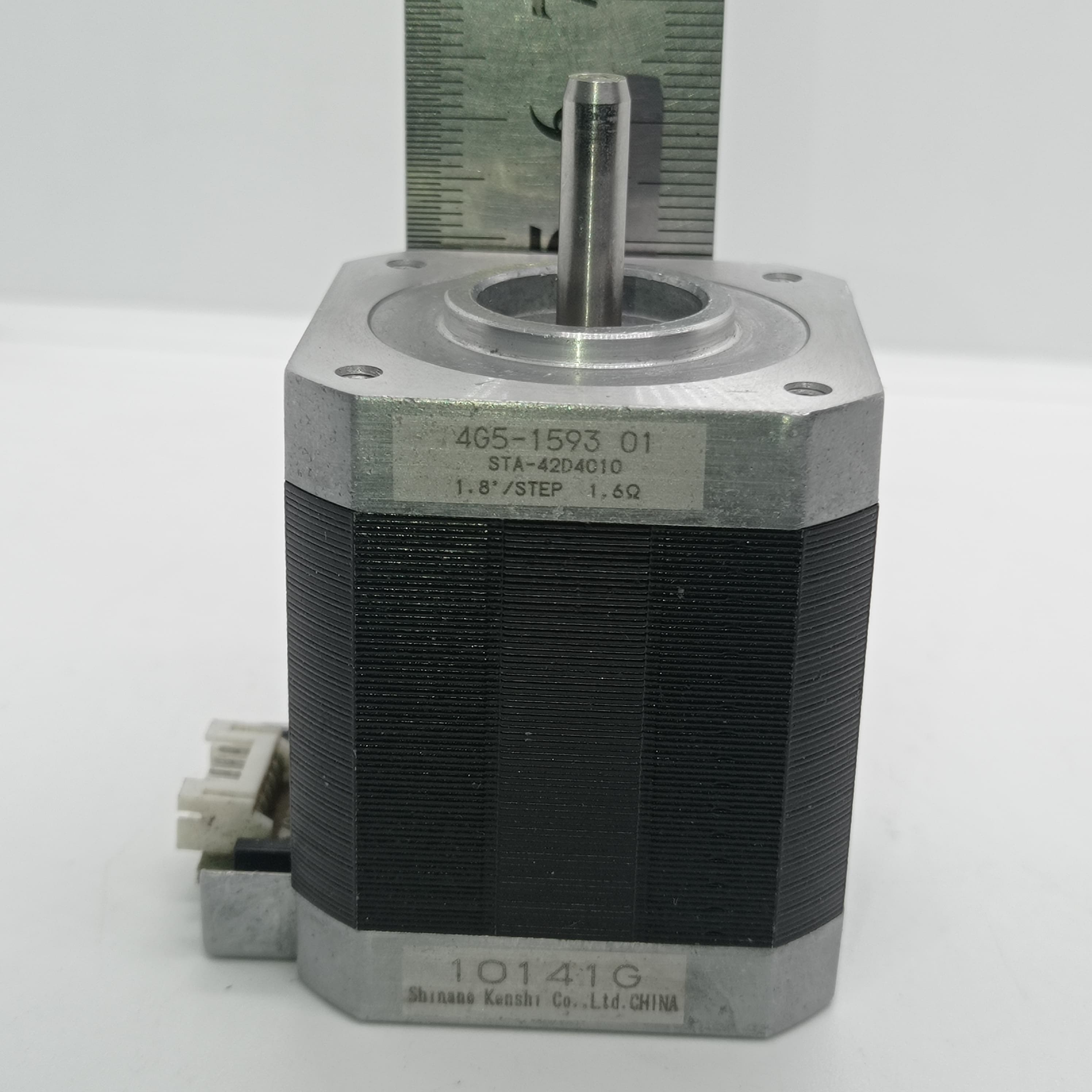 Shinano Kenshi STP-42D4042 2A 1.8 Degree Per Step 0.53nm Stepper Motor - a silver metal shaft, a black body with a label reading 4G5-1593 01, and a white electrical connector on the side.